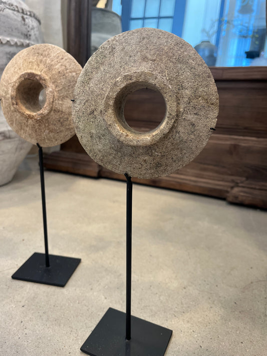 Mini antique millstones on stands