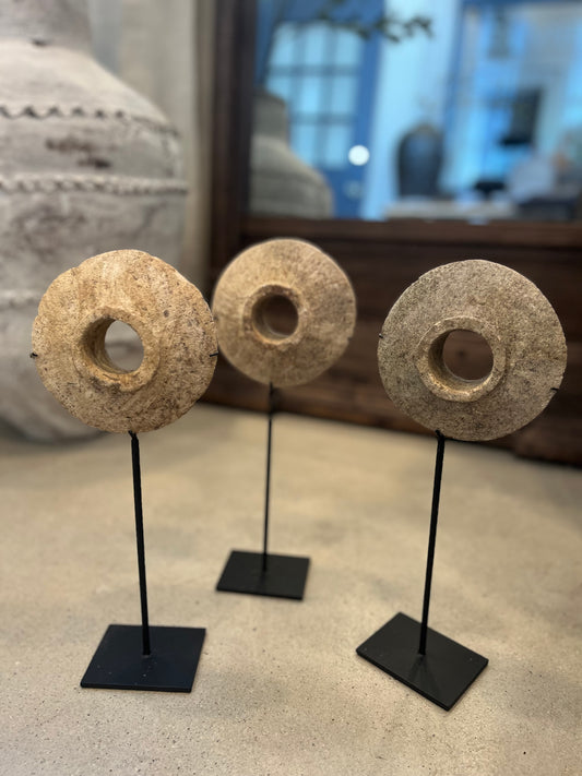 Mini antique millstones on stands