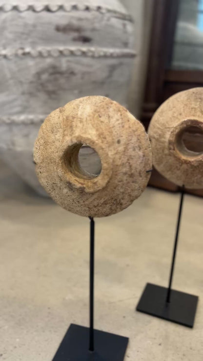 Mini antique millstones on stands